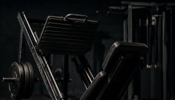 Leg press machine in a quiet gym, set up for a beginner machines-only leg day