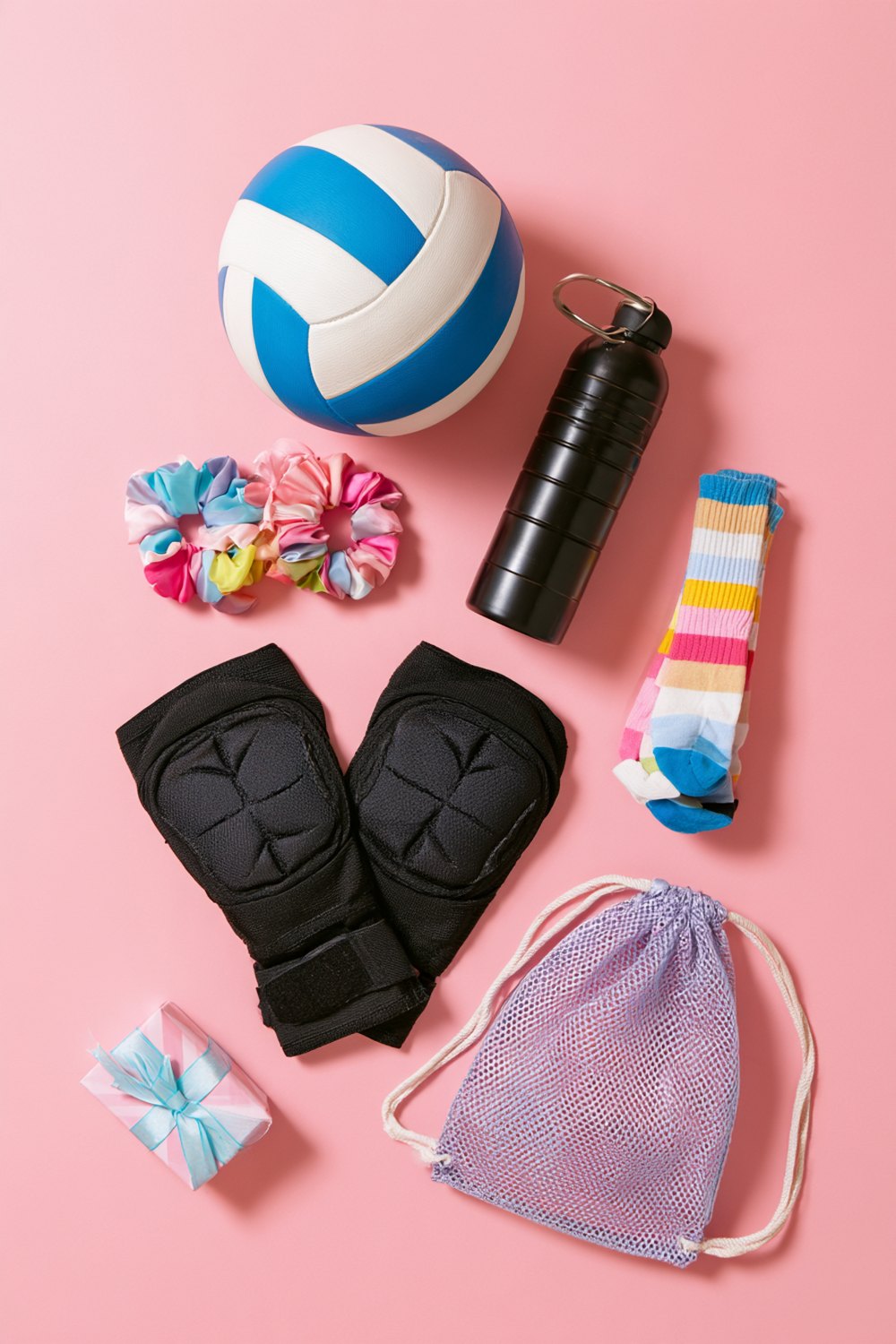 Volleyball, black knee pads, scrunchies, a black water bottle and a lavender mesh bag arranged as gift ideas