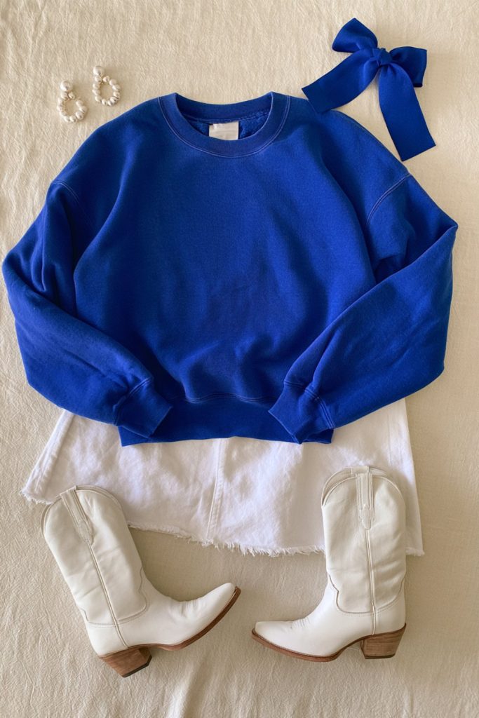 Royal blue sweatshirt, white skirt and blue bow laid out for a Kentucky game day