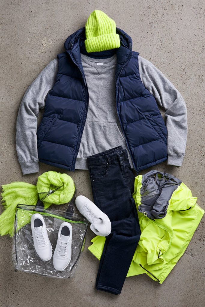 Navy, wolf grey and lime green game day layers with a clear stadium bag on concrete
