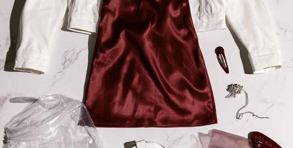 Texas A&M game day outfits flat lay with a maroon satin slip dress, white denim jacket, white western boots and a clear bag