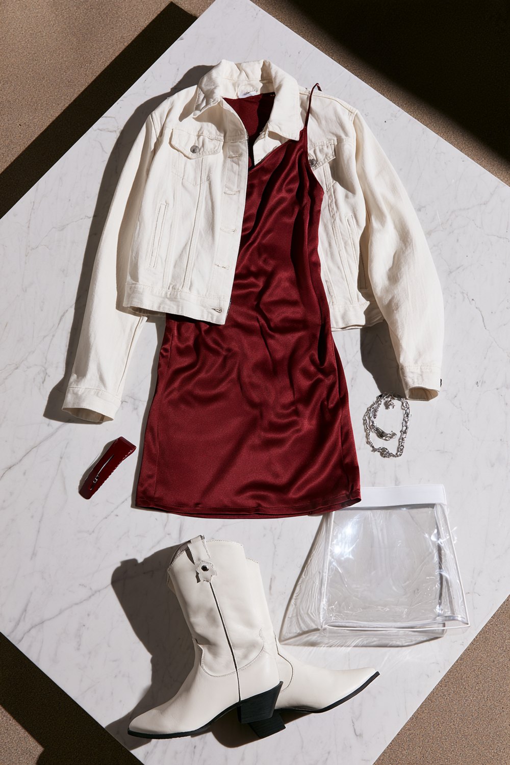 Maroon slip dress with a cropped white denim jacket and white boots for Kyle Field
